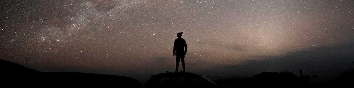 A sky of stars with a man in the foreground